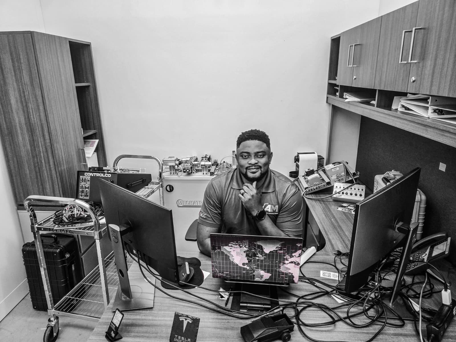 Ernest Afuta working in an advanced manufacturing and controls lab
